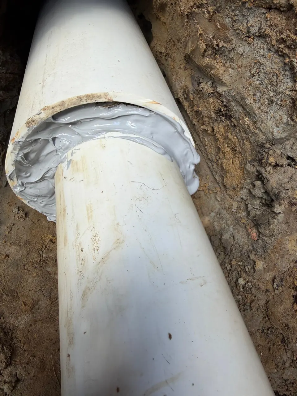 Sewer pipe joint packed and sealed with gray compound