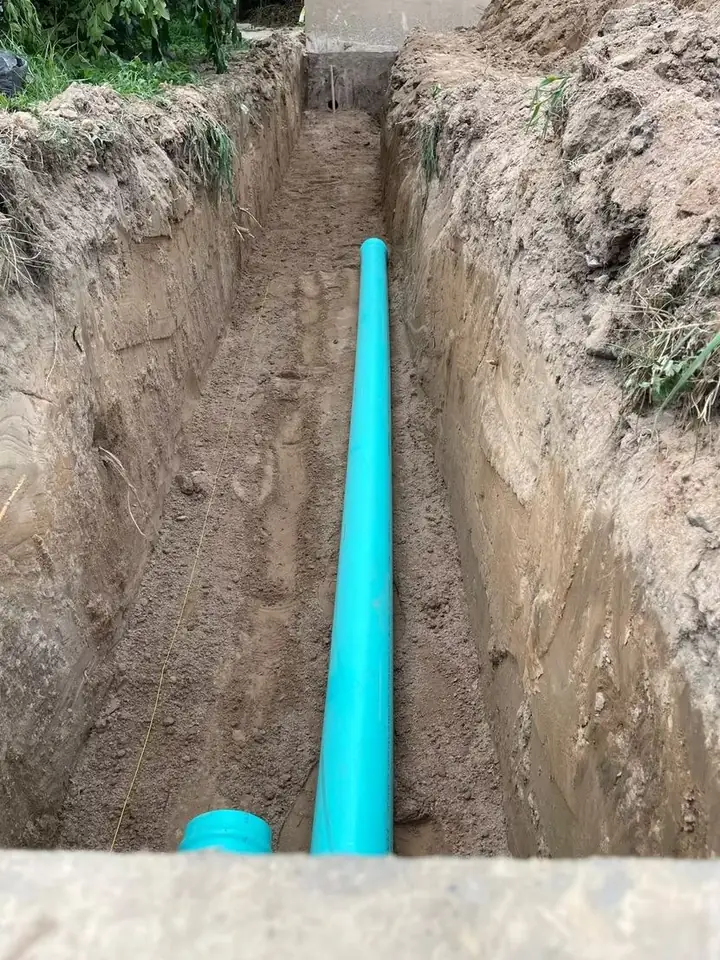 Main water line in an open trench before backfill